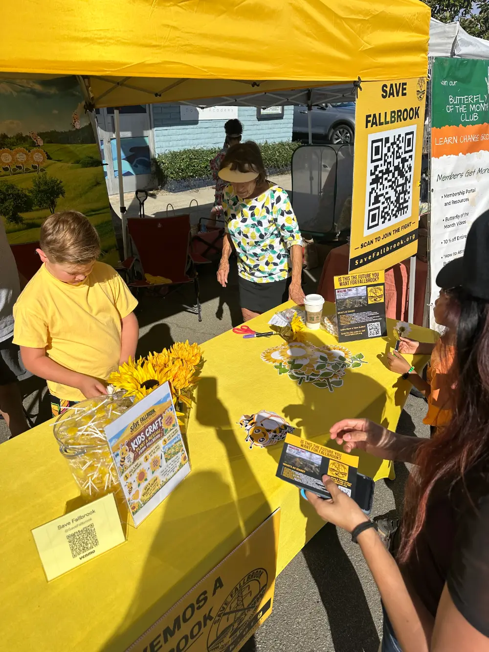 The yellow Save Fallbrook Kids Craft booth at the Fallbrook Harvest Faire